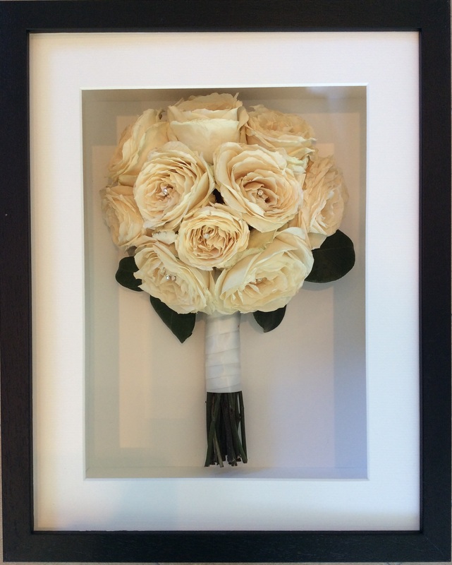 a simple white side view preserved wedding bouquet in a frame