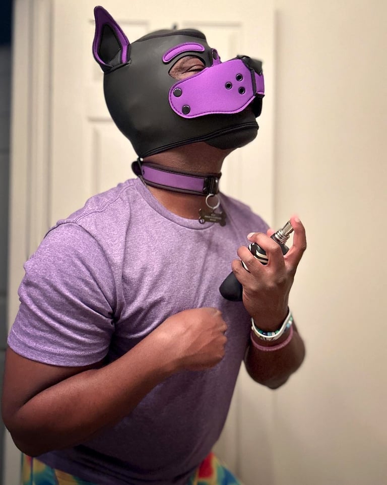 Man in a pup mask spraying on some perfume.