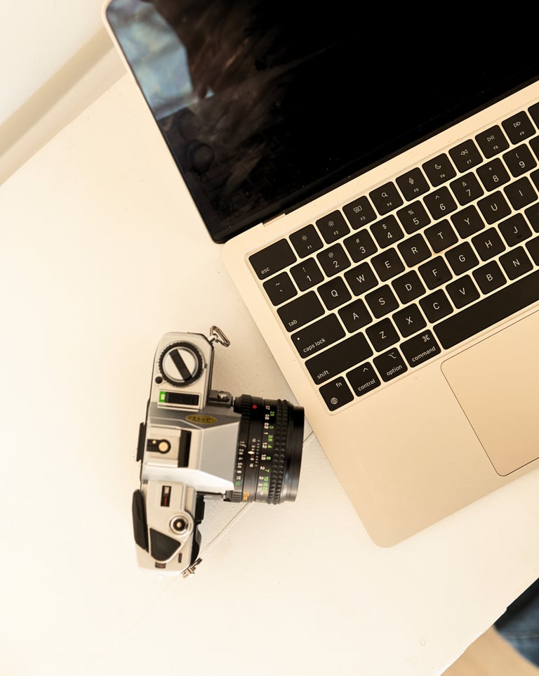 a camera and a labtop on a table