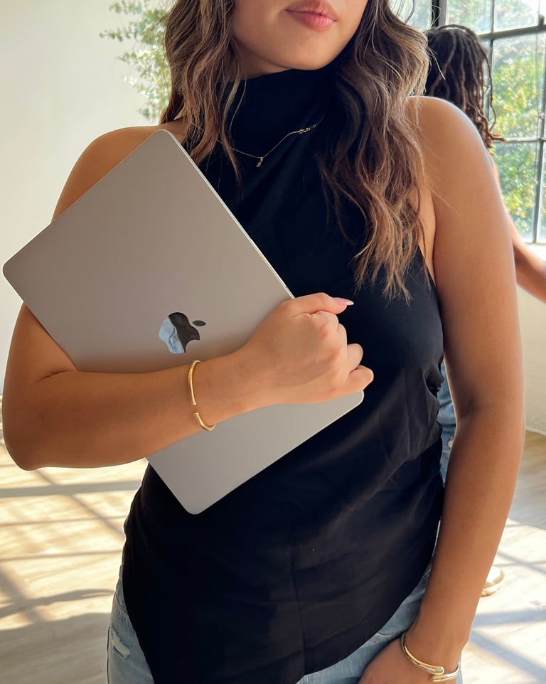 a woman holding a laptop computer