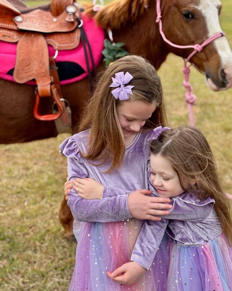 All hugs and joy after riding Snickers at a princess pony party