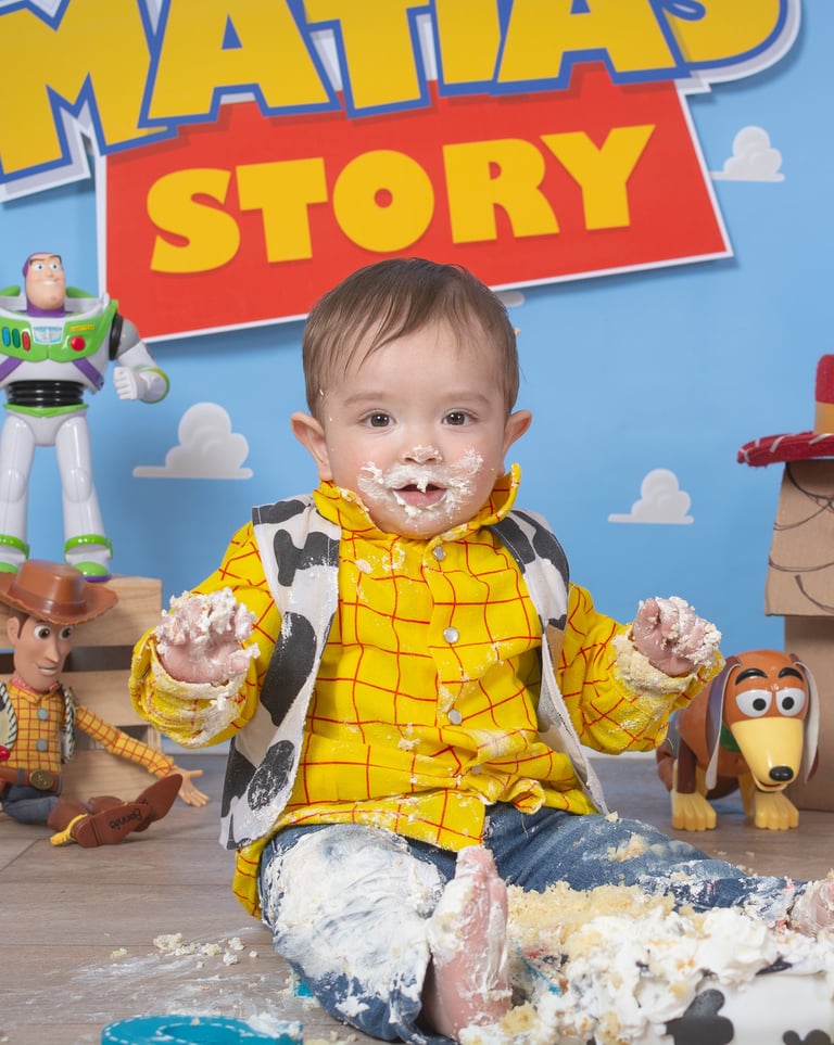 a baby boy in a yellow shirt and blue jeans