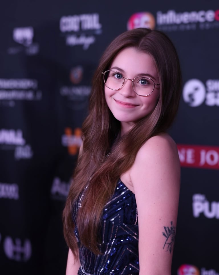 a woman with glasses and a tattoo on her arm