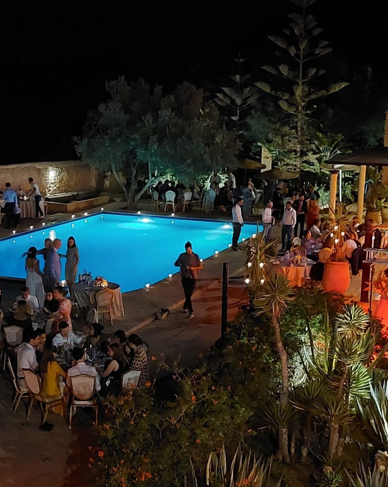 a pool with people standing around a pool