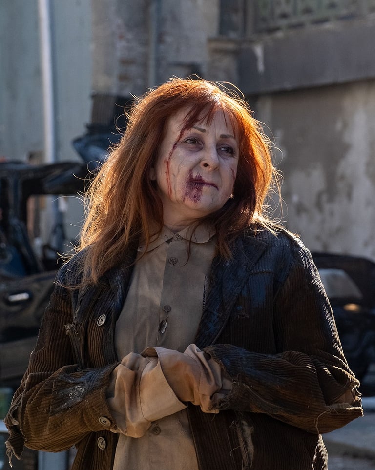 Portrait of an actress looking to the right  in zombie clothing and makeup on set