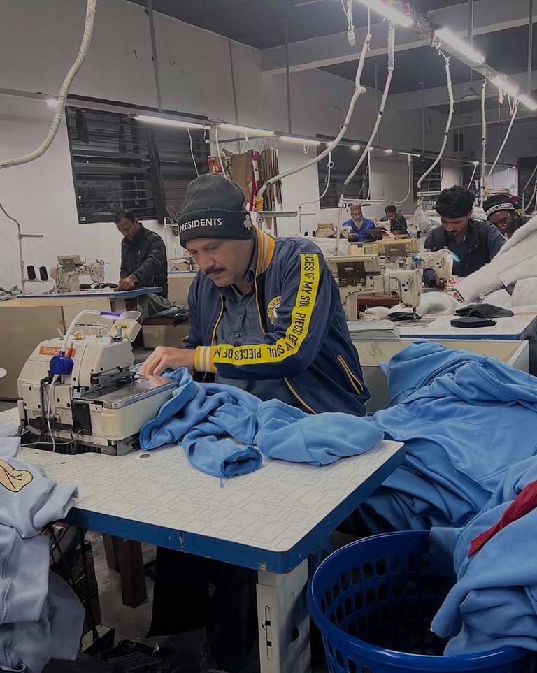 a man in a blue shirt is sewing a blue shirt