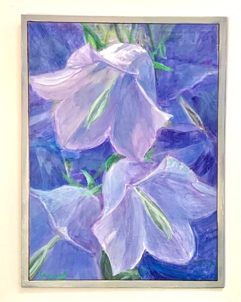 Closeup of three Bluebell flowers lit by the sun