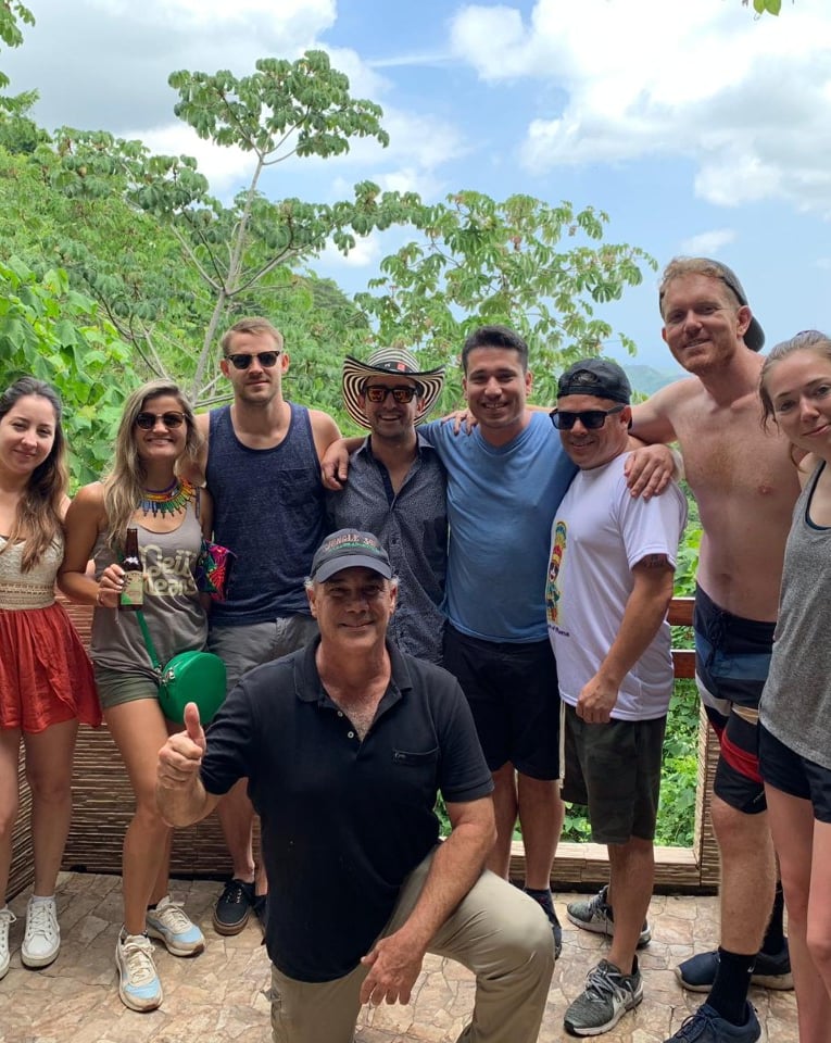 a group of people standing around a wooden fence