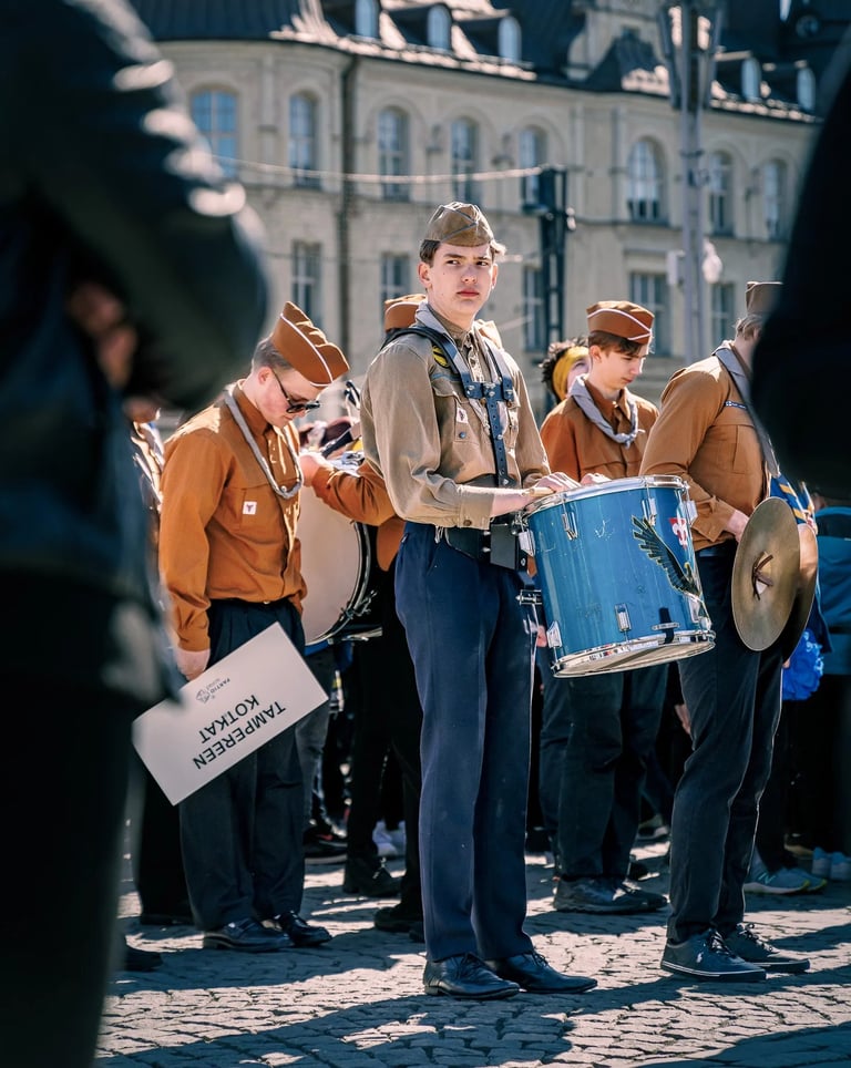 a man in a uniform is holding a drum and a drum