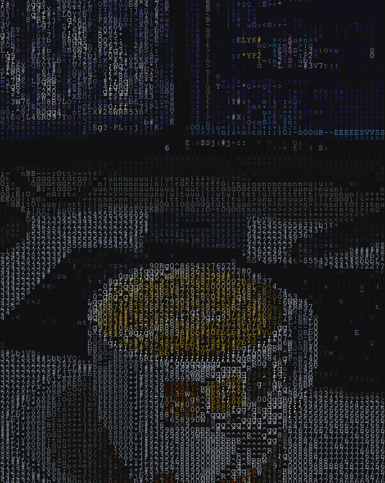 coding with a cup of coffee on a table in front of a dual screen setup with keyboard