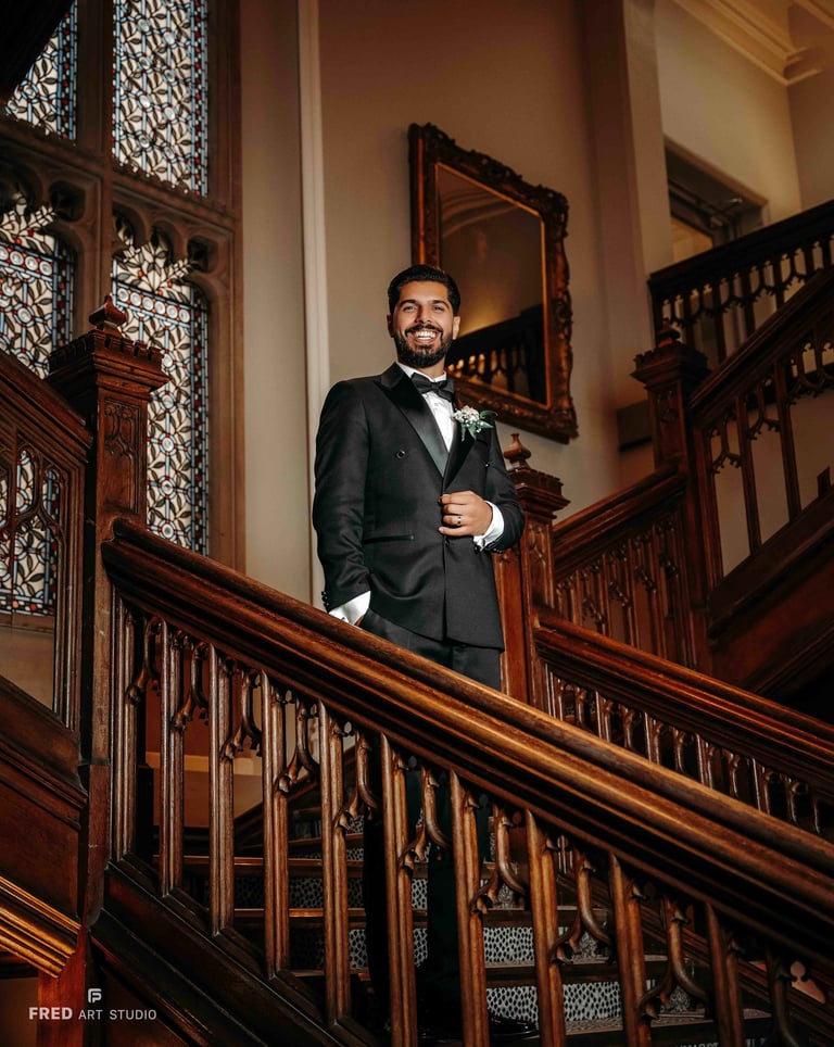 Groom portrait on elegant wooden staircase – classic Oxford wedding photography by Fred Art Studio