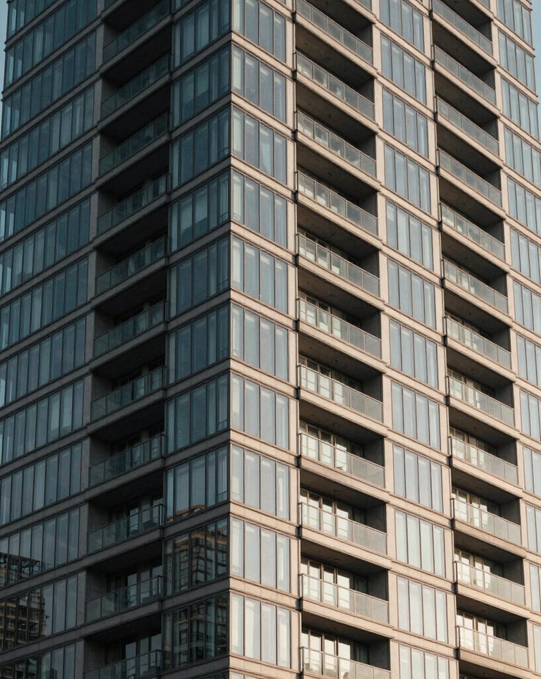 A vertical architectural shot of a modern glass high-rise facade against a clear sky. The focus is on the repetitive patterns of the balconies and windows. The style is professional and trustworthy, utilizing slate gray and off-white colors.