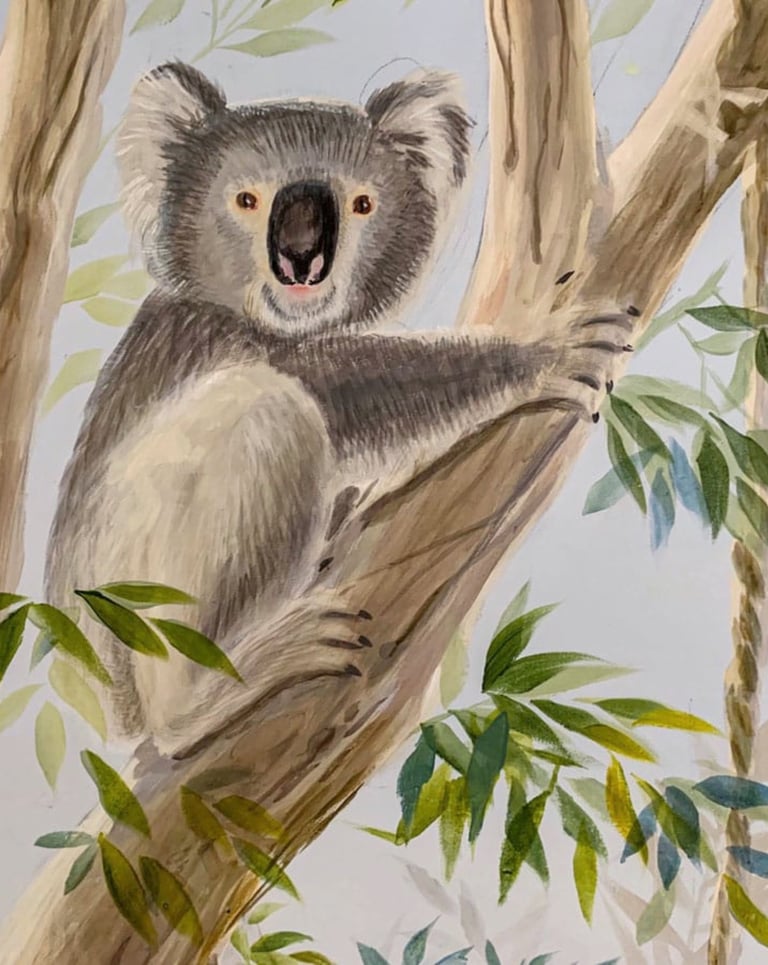 Hand-painted koala resting in a gum tree — Australian nursery mural detail in calm neutral tones.