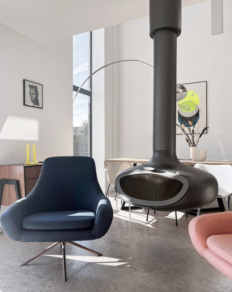 open-plan-living-space-with-floating-fireplace artwork and Softline armchairs