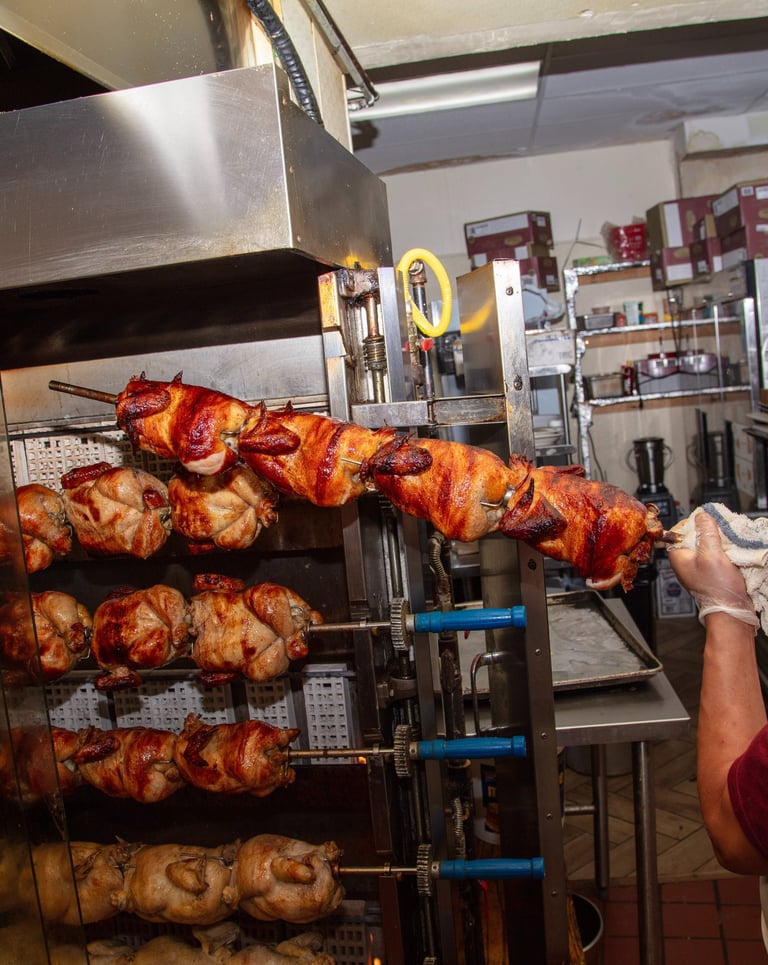 a man in a red shirt is holding a large rack with chicken