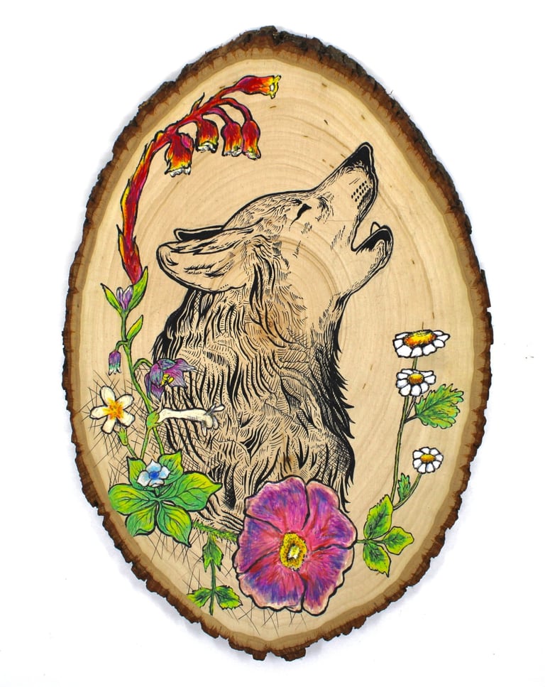 a drawing of a wolf and flowers on a wood slice