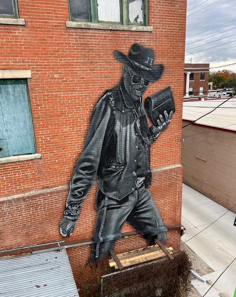 Mural in Terrell, Texas by Ryan Stalsby Spray Paint Portrait on wall
