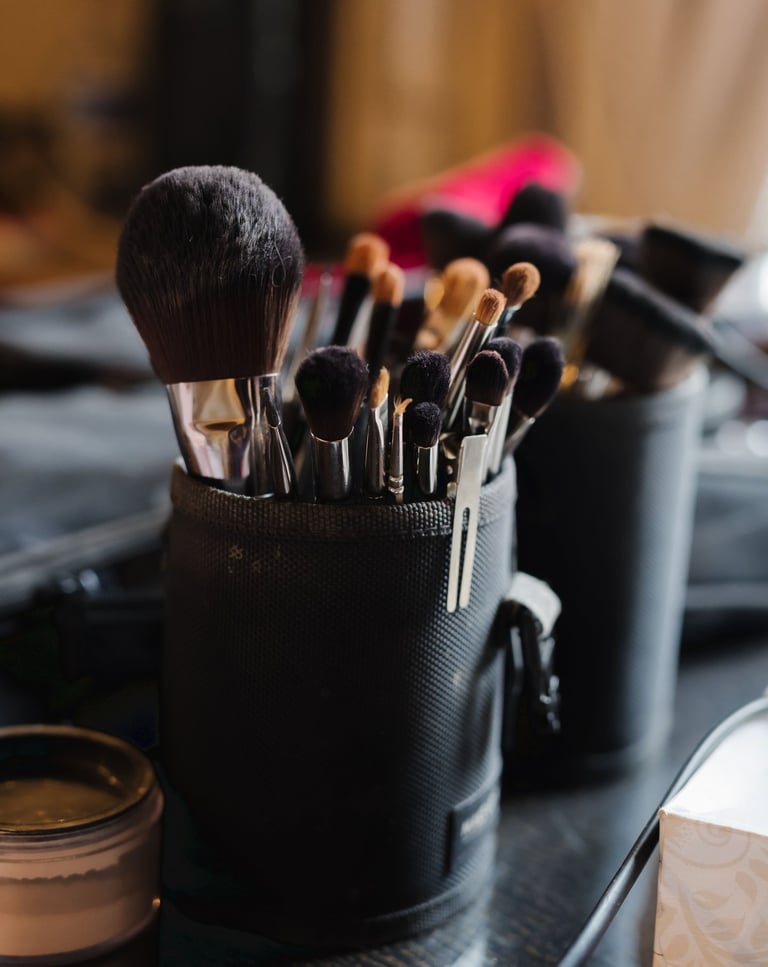 un tas de pinceaux de maquillage et de brosses dans un récipient noir