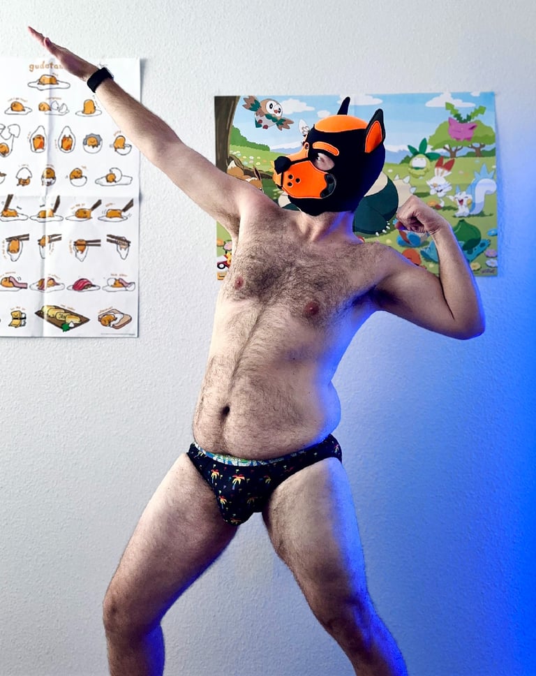 Man striking a classic pose in his underwear and a pup mask.