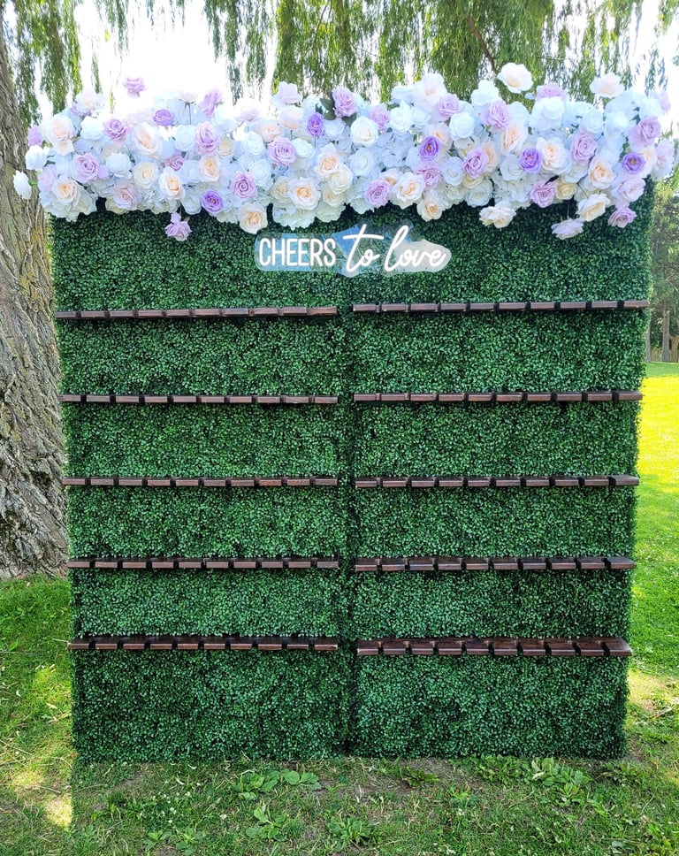 Champagne wall with lavender and white top flower arrangement.