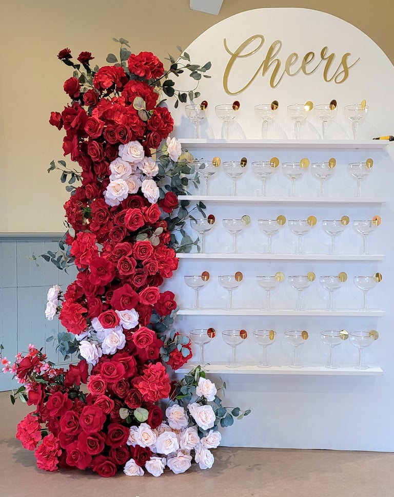 7ft x 4ft white champagne wall/treat wall display of red flowers mixed with blush pink roses