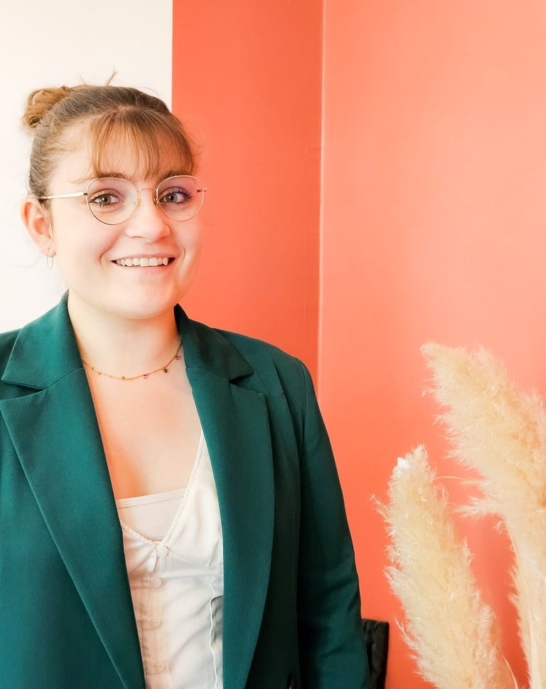 a woman in a green jacket and glasses