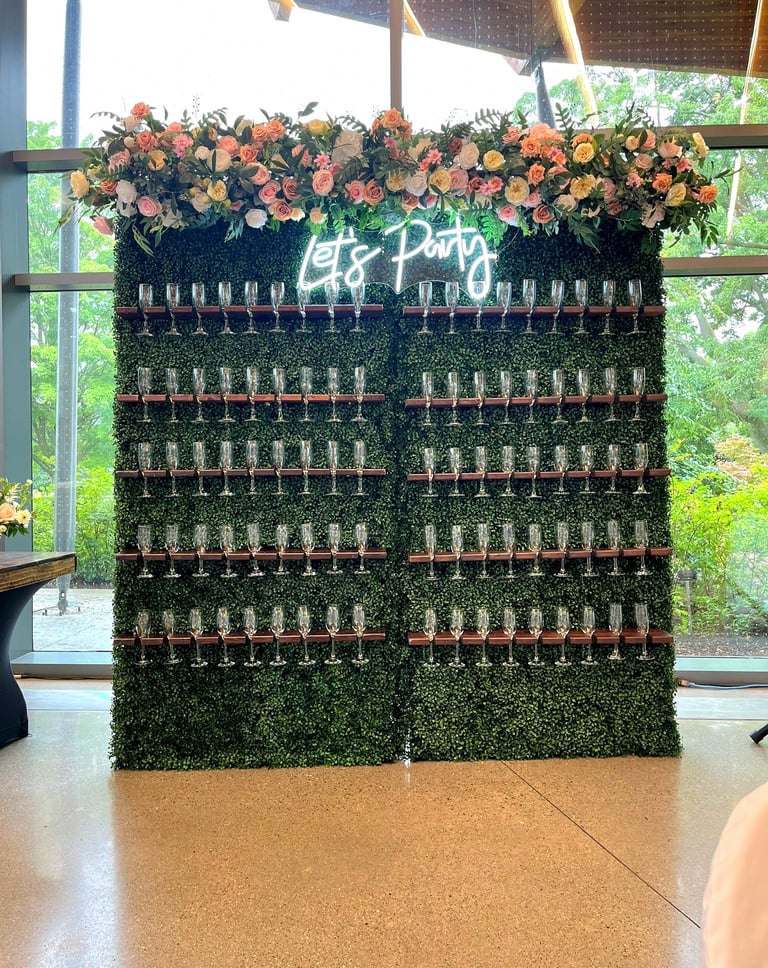 a wall of wine glasses with a green champagne wall wall
