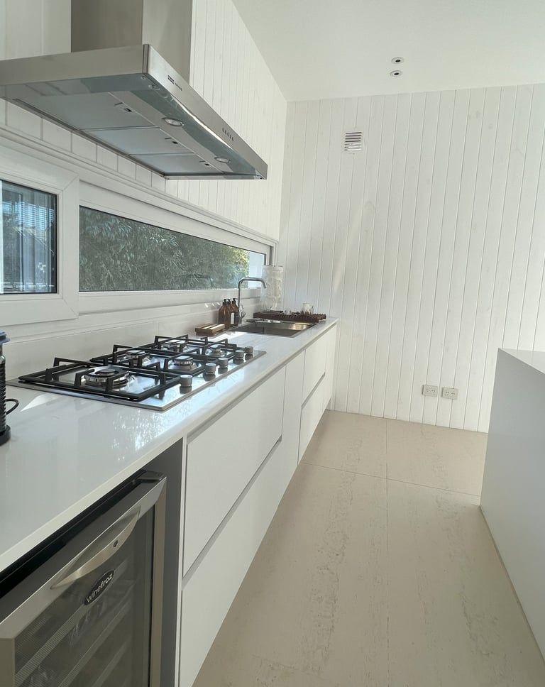 a kitchen with a stove top and a stove top