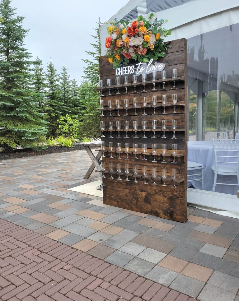 Custom made brown stained champagne wall for an outdoor wedding with fall florals