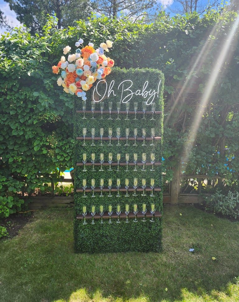 grass champagne wall with tropical floral arrangement