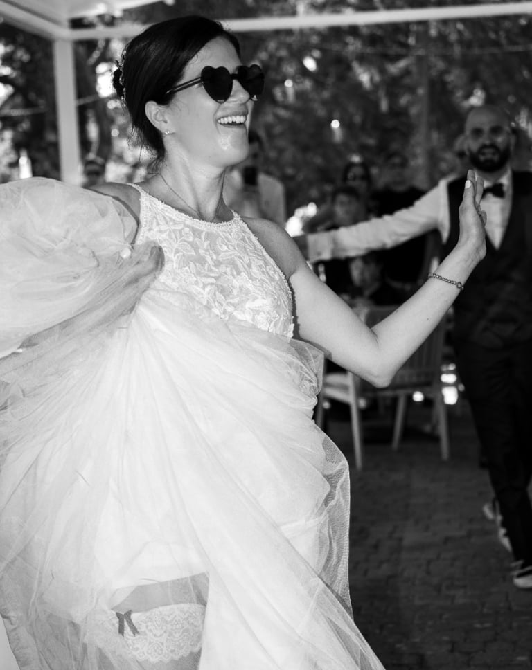 a woman in a wedding dress dancing with a man in a suit
