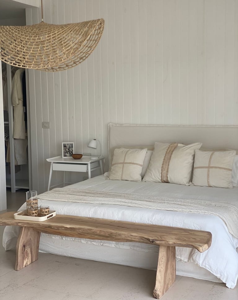 a bed with a wooden bench and a bench with a bench and a table with