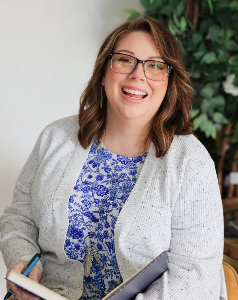 a woman in glasses and a blue top