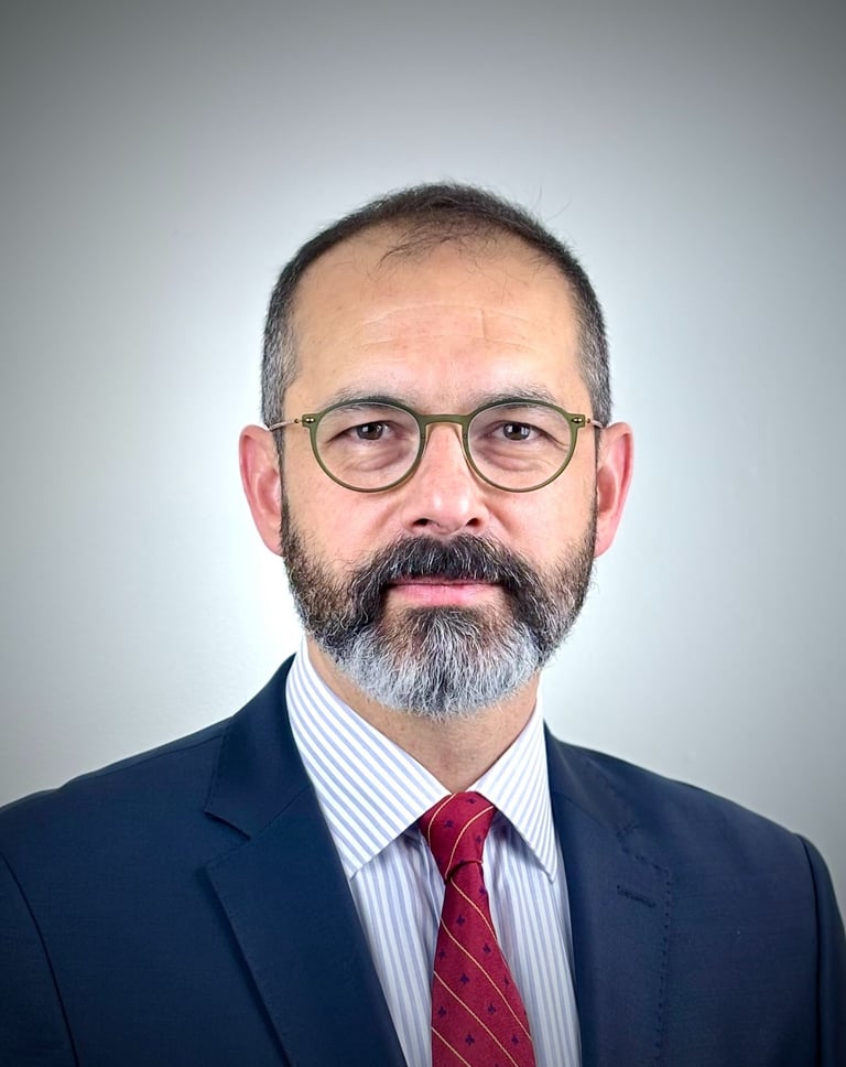 a man with a beard and glasses on a white background