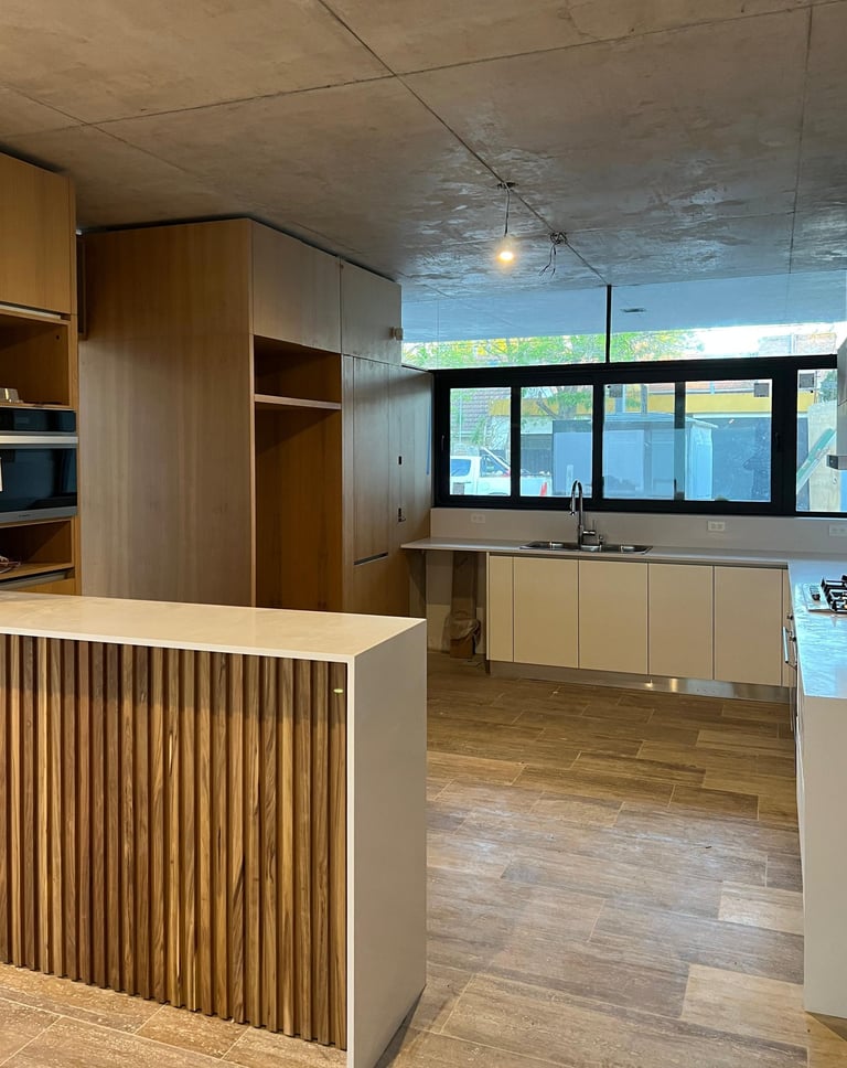 a kitchen with a wooden counter top and a wooden counter top