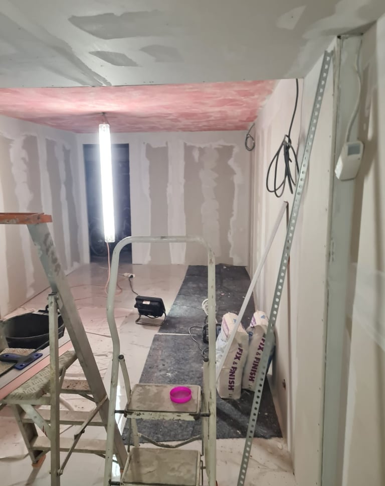 Travaux intérieurs en cours : pose de cloisons en plaques de plâtre et préparation des plafonds