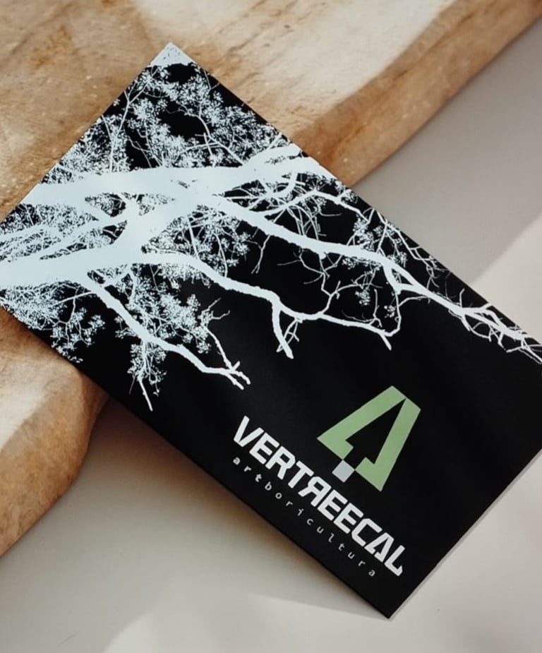 A Vertrecal arboricultural business card with a white tree silhouette on a black background.