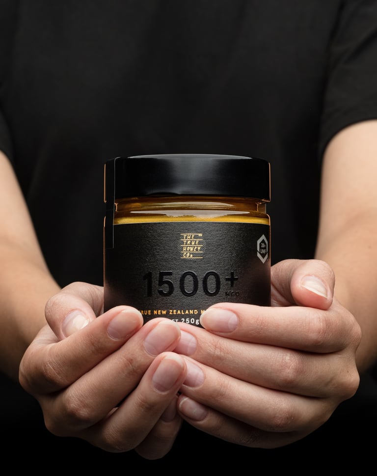 Product photography - a person holding a jar of honey