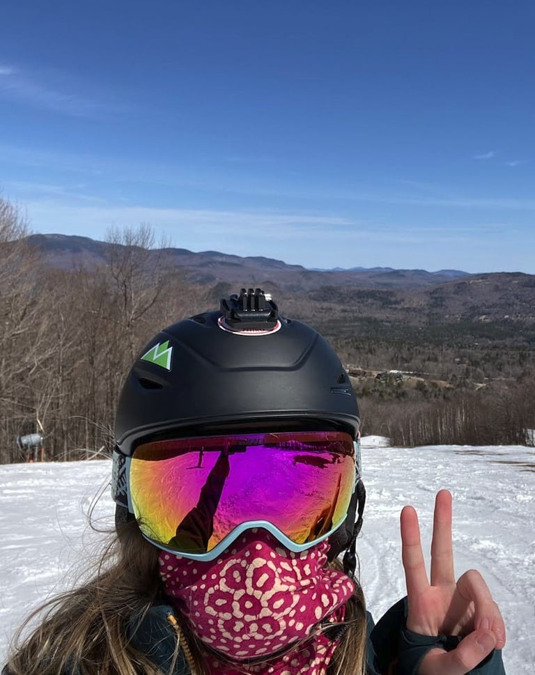 girl skiing giving peace sign