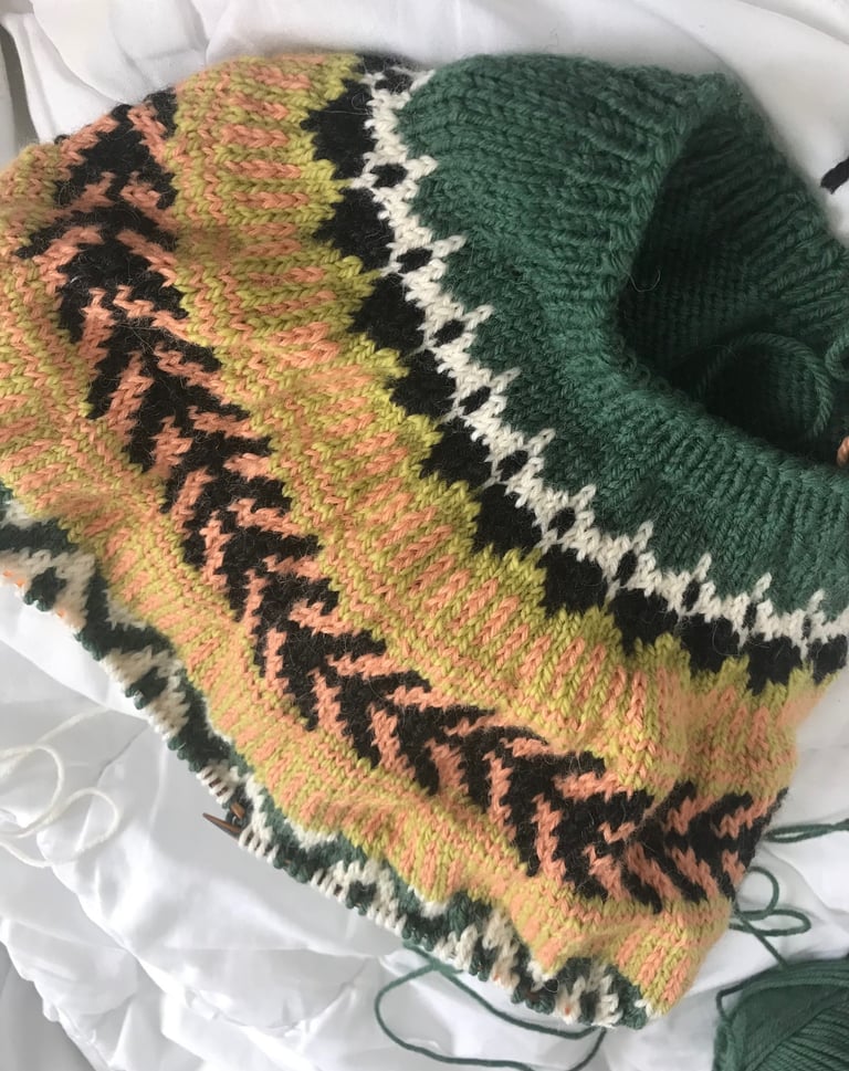 A knitted sweater sample with fair isle stitch pattern. It is handknitted