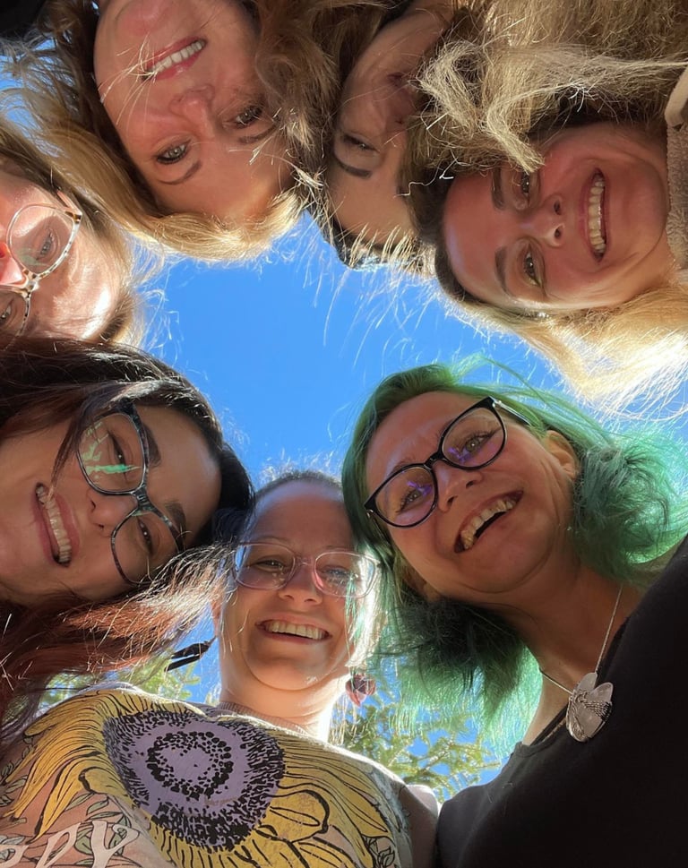 a group of women standing in a circle