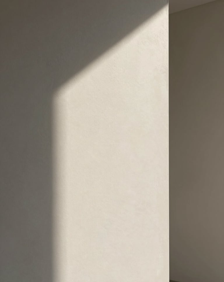Abstract photography of light hitting a textured wall in a modern building, soft off-white and medium grey tones, elegant and minimalist composition.