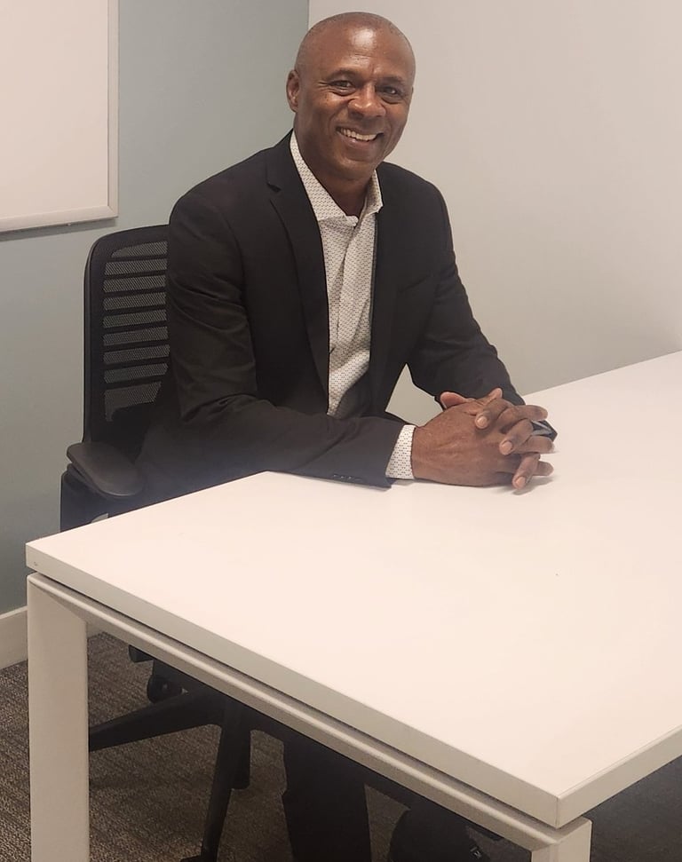 a man in a suit and tie sitting at a table