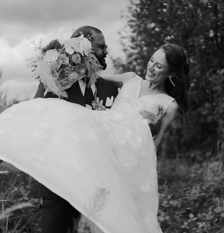 a bride and groom are holding their wedding dress