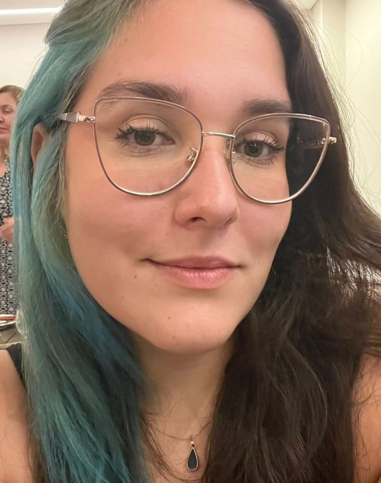 a woman with blue hair and glasses on her face