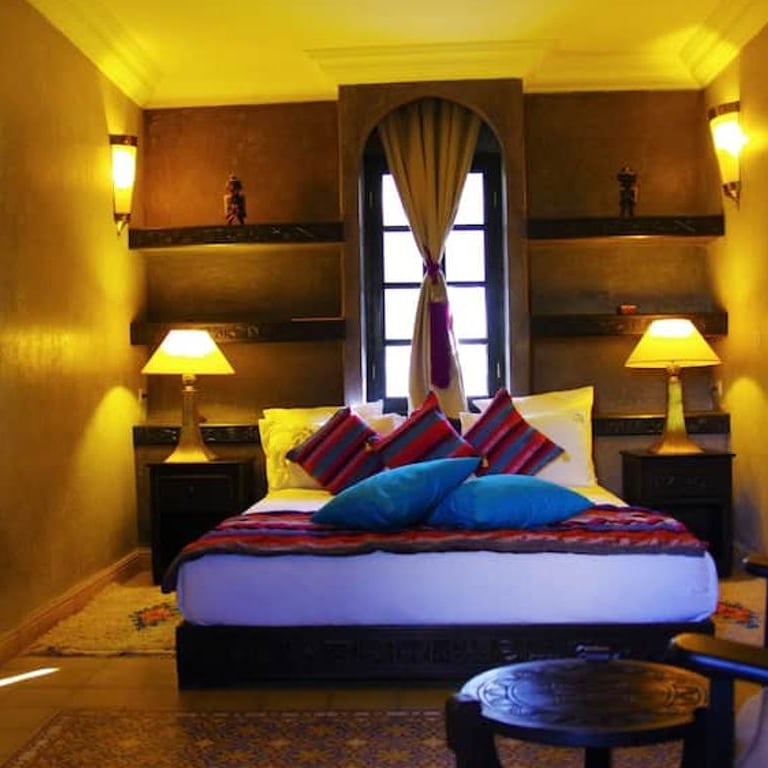 a bedroom with a bed and a chair