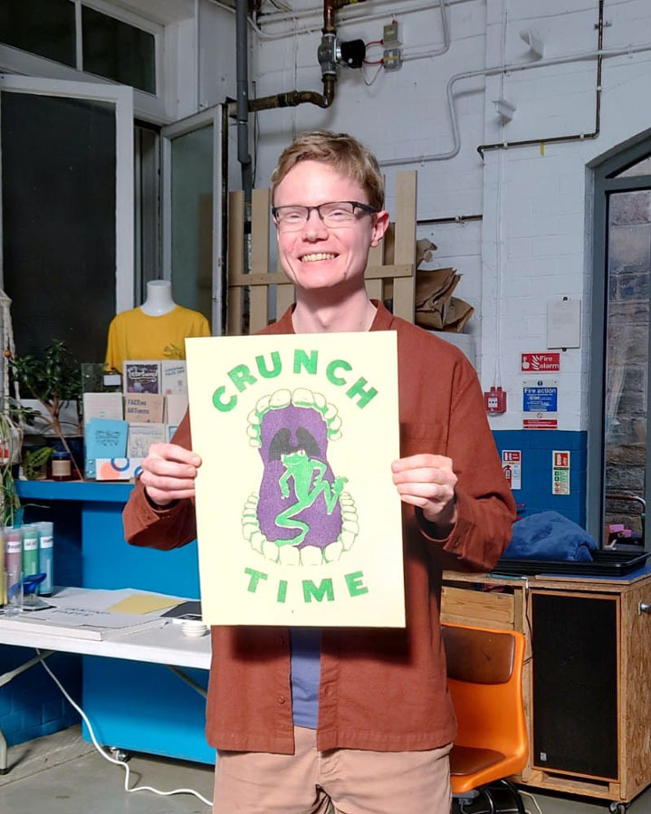 Bio photo of Illustrator Ben Harley holding his own riso print.