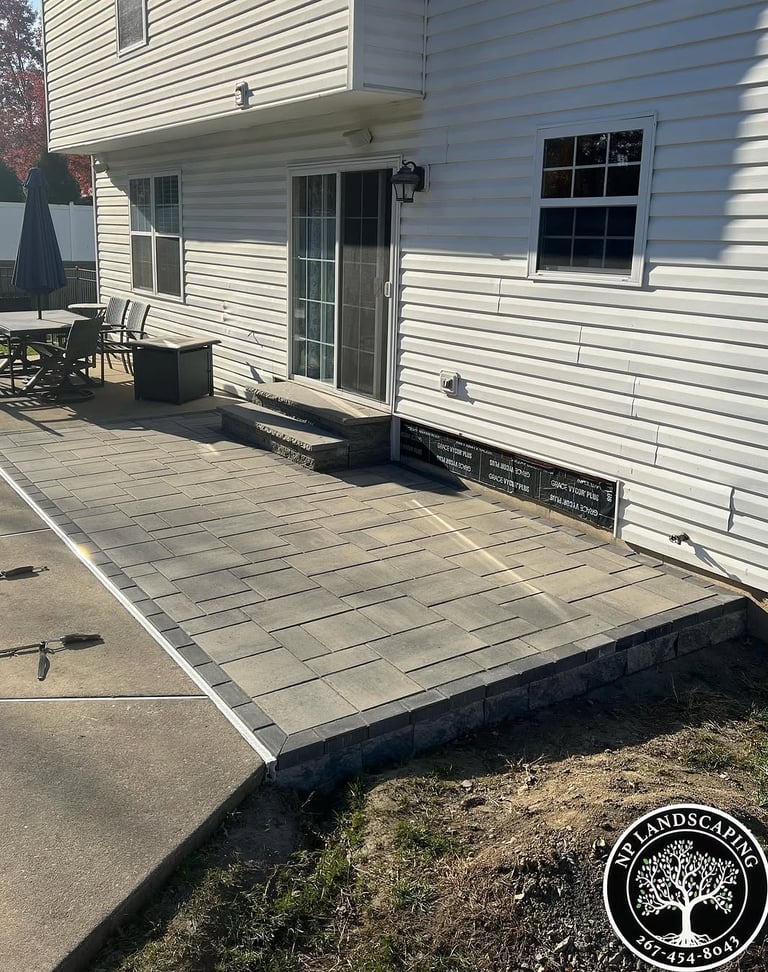 excellent landscaping and hardscaping of grass, stones and trees by NP Landscaping