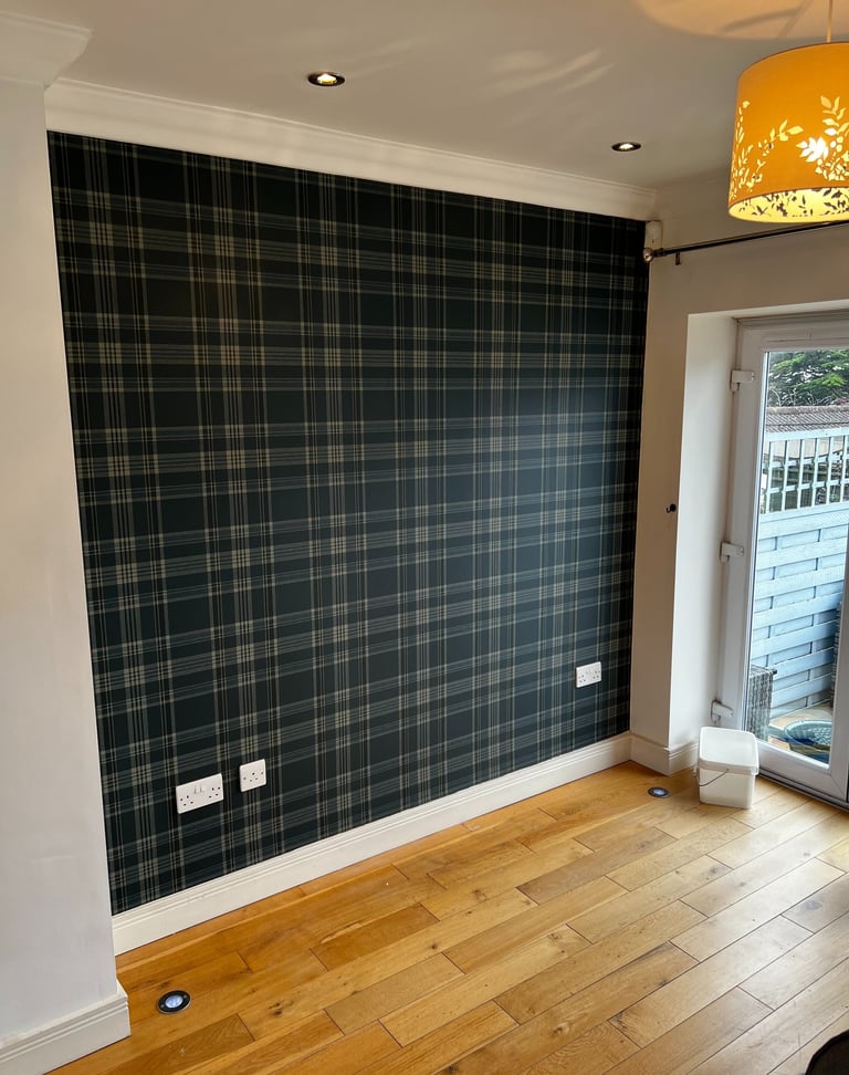 Modern living room featuring a dark grey tartan plaid feature wall and light oak hardwood flooring.
