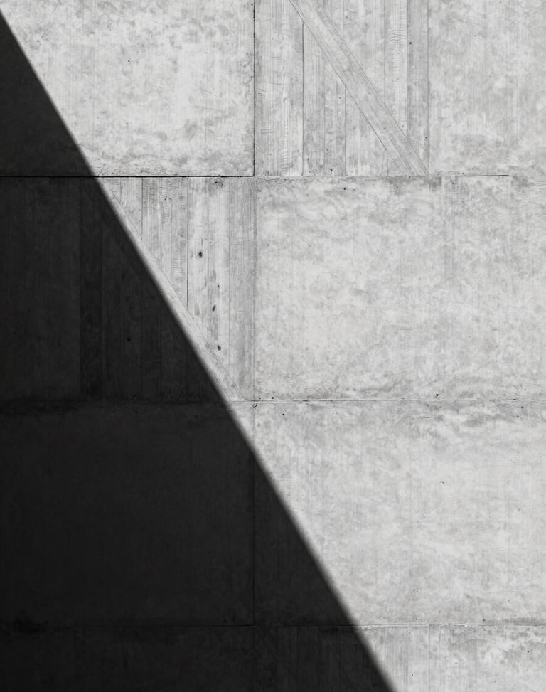 Raw concrete wall texture with geometric wooden board formwork patterns, harsh midday sun casting sharp shadows, high contrast, minimalist architectural photography